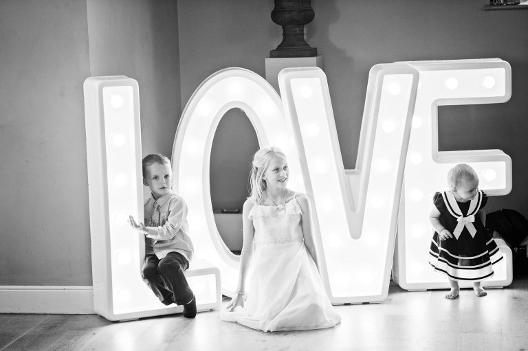 Love letters lit up with children in front of them.