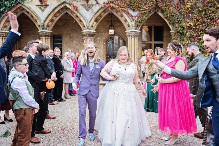 Bride and groom (James Moore), walking down the wedding isle whilst wedding guests throw confetti at them.