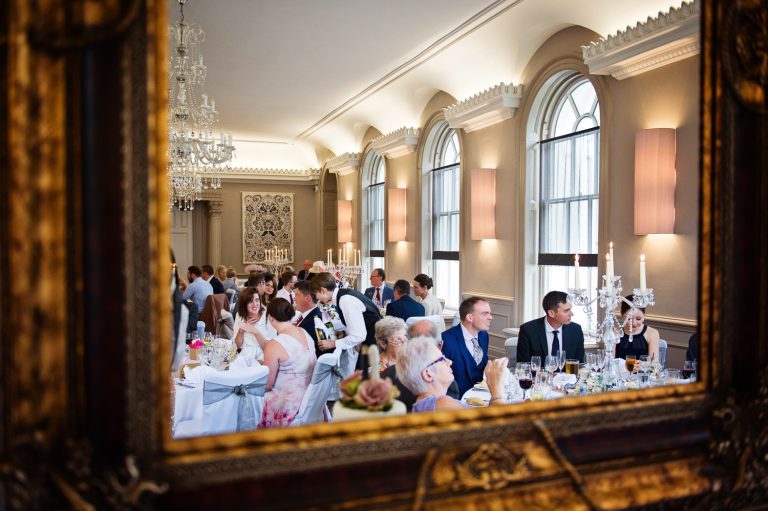 Reflection from a mirror of guests having a good time at The Queens Hotel, Cheltneham.