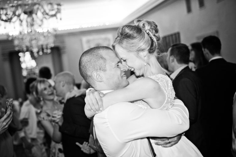 Bride and groom grab each other during the 1st dance, candid pic.