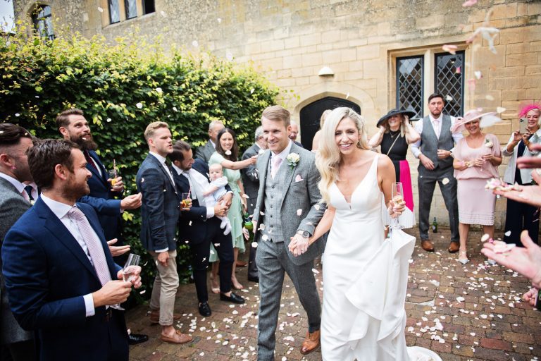 Confetti being thrown at bride and groom after their wedding at Ellenborough Park