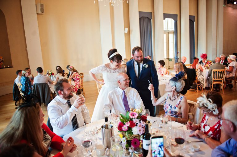 Bride and groom chat to their wedding guests during the wedding breakfast at Pittville Pump Rooms.