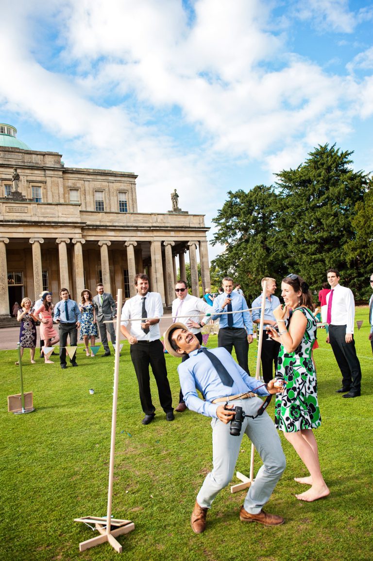Wedding guests playing games (such as the limbo), in the grounds of Pittville Pump Rooms.