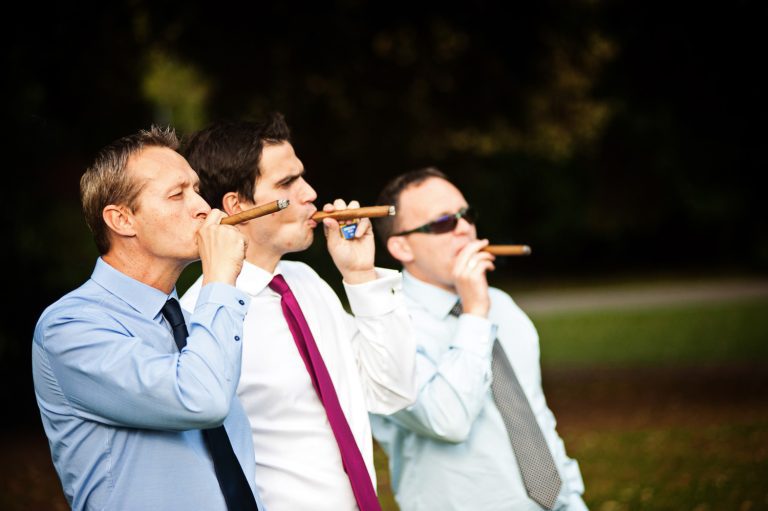 Gentlemen puffing on cigars.