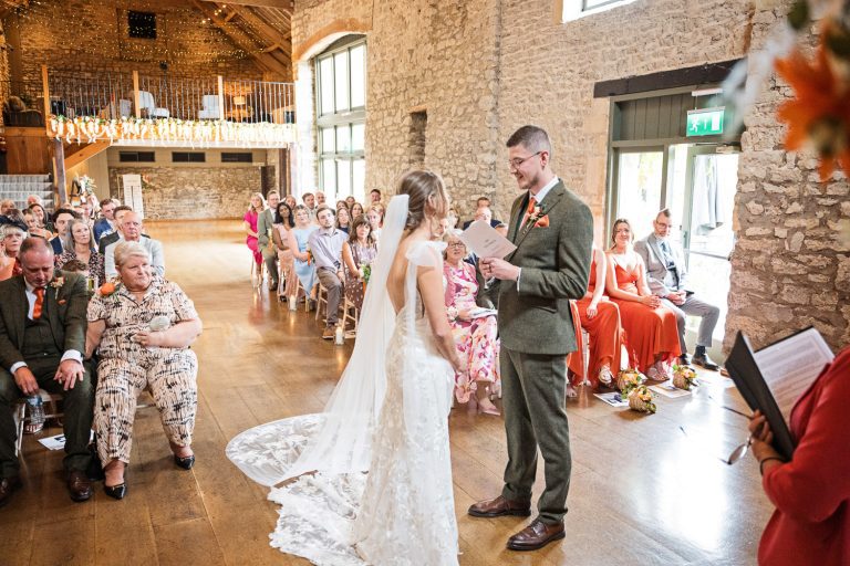 Groom reading his personal vows at a wedding ceremony at Priston Mill.
