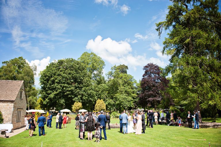 Wedding guests relax in the grounds at The Slaughters Country Inn