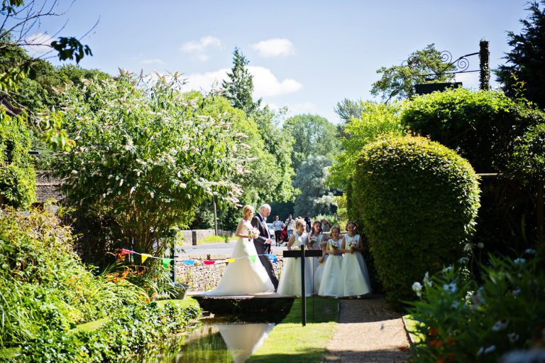 Bridle part about to walk down the wedding isle in the gardens of Bibury.
