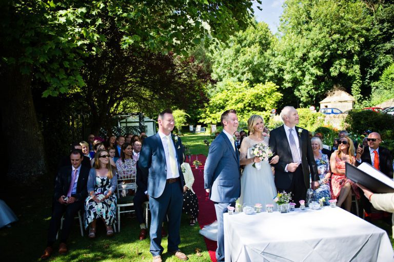 Wedding ceremony taking place in the gardens at The Swan Hotel, Bibury.