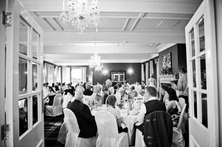 B&W photo of a Wedding breakfast taking place at The Swan Hotel, Bibury