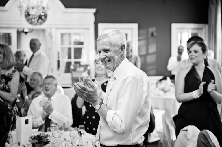 B&W image of guests clapping.