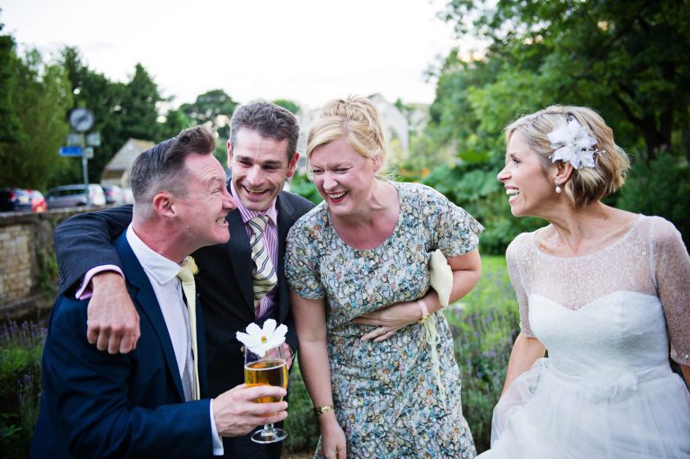 Casual photo of bride having fun with her friends, laughing.
