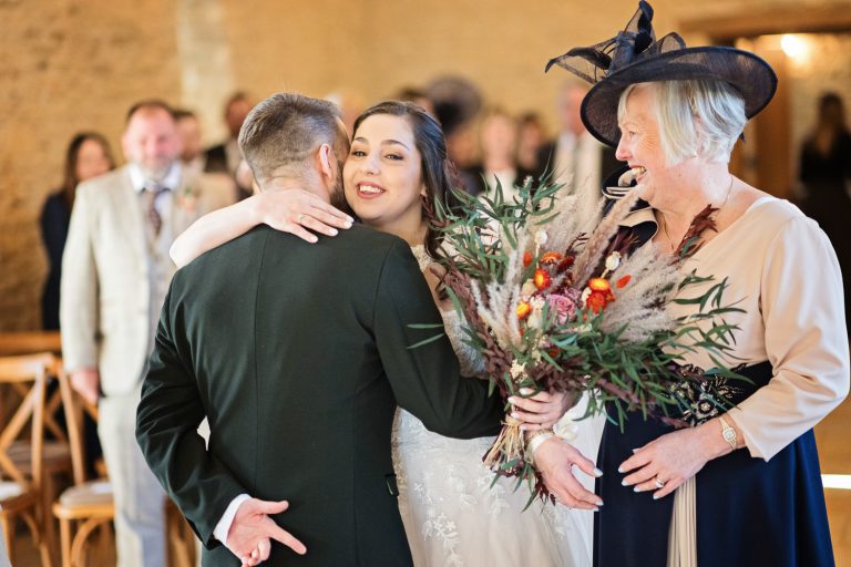Bride hugs her husband as she gets to the alter.