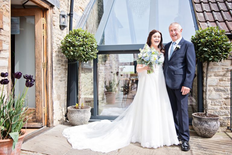 Father of the bride and bride smiling at Kingscote Barn