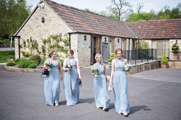 Bridesmaids walking towards wedding venue.