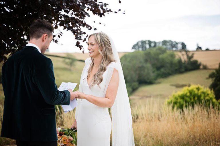 Bride and groom saying their private vows together at Kingscote Barn One Tree Hill