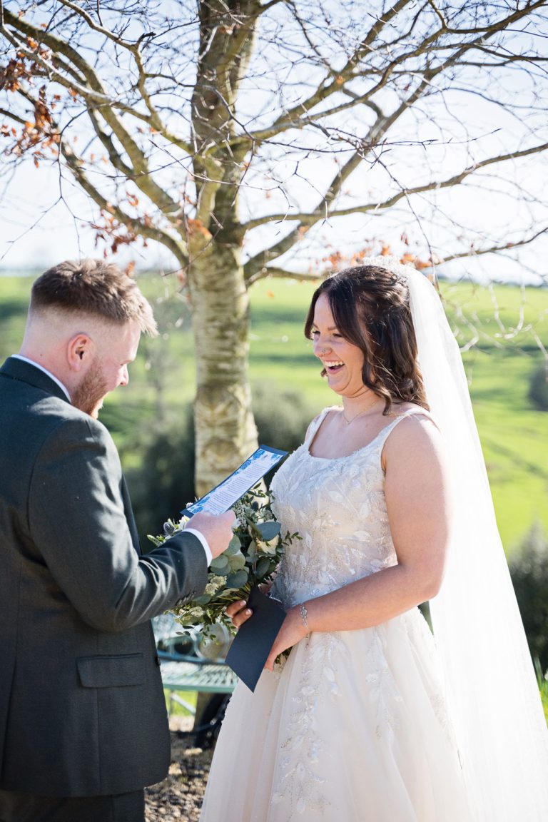 Bride and groom saying their private vows together at Kingscote Barn One Tree Hill