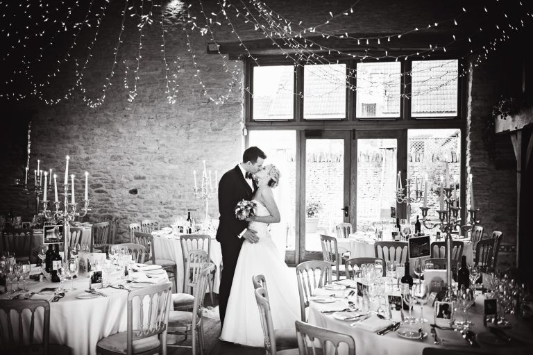 Bride and groom in a Cotswold Kingscote Barn.