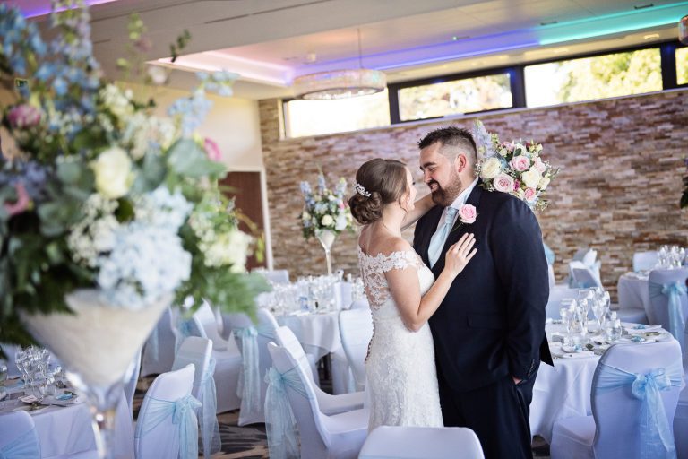 Candid pic of bride and groom grabbing a moment in the Cotswold Suite at Tewkesbury Park.