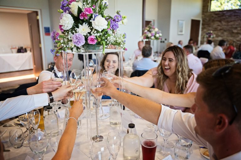 Documentary photo of wedding guests enjoying themselves at Tewkesbury Park in the Cotswold Suite.