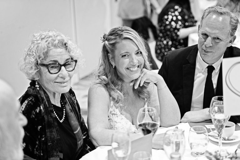 Documentary photo of bride enjoying her wedding guests at Tewkesbury Park in the Cotswold Suite.