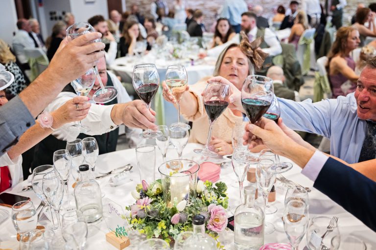 Documentary photo of wedding guests at Tewkesbury Park in the Cotswold Suite.