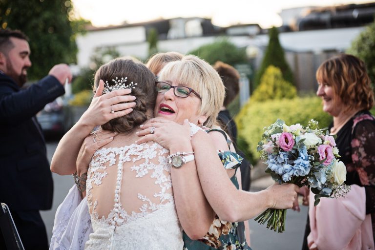 Documentary image of a wedding guests congratulating the bride at Tewkesbury Park