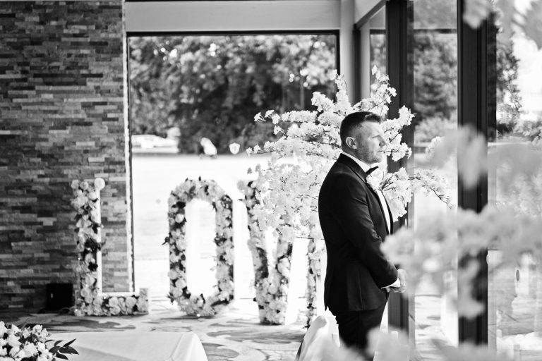 Pensive moment for a groom about to get married at Tewkesbury Park.