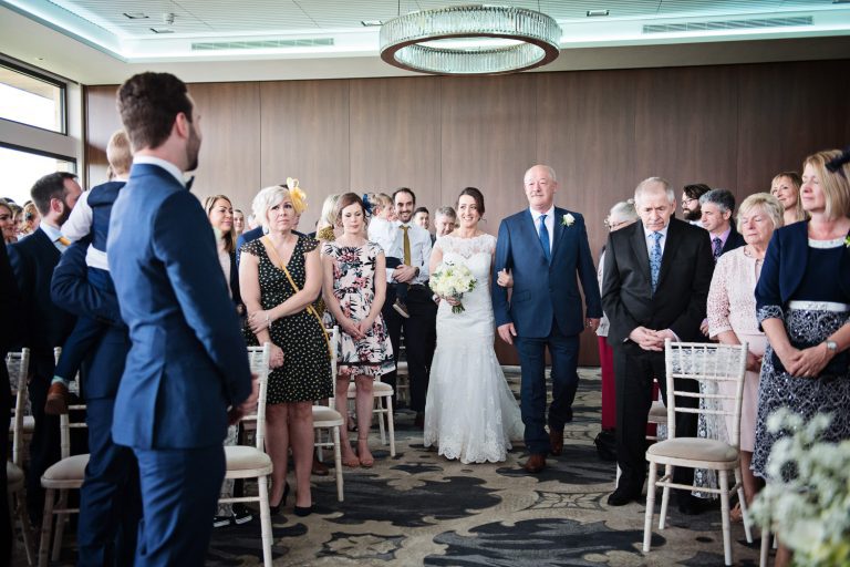 Bride walks down the wedding isle at Tewkesbury Park hotel.