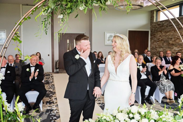Candid moment of groom and bride at a wedding at Tewkesbury Park.