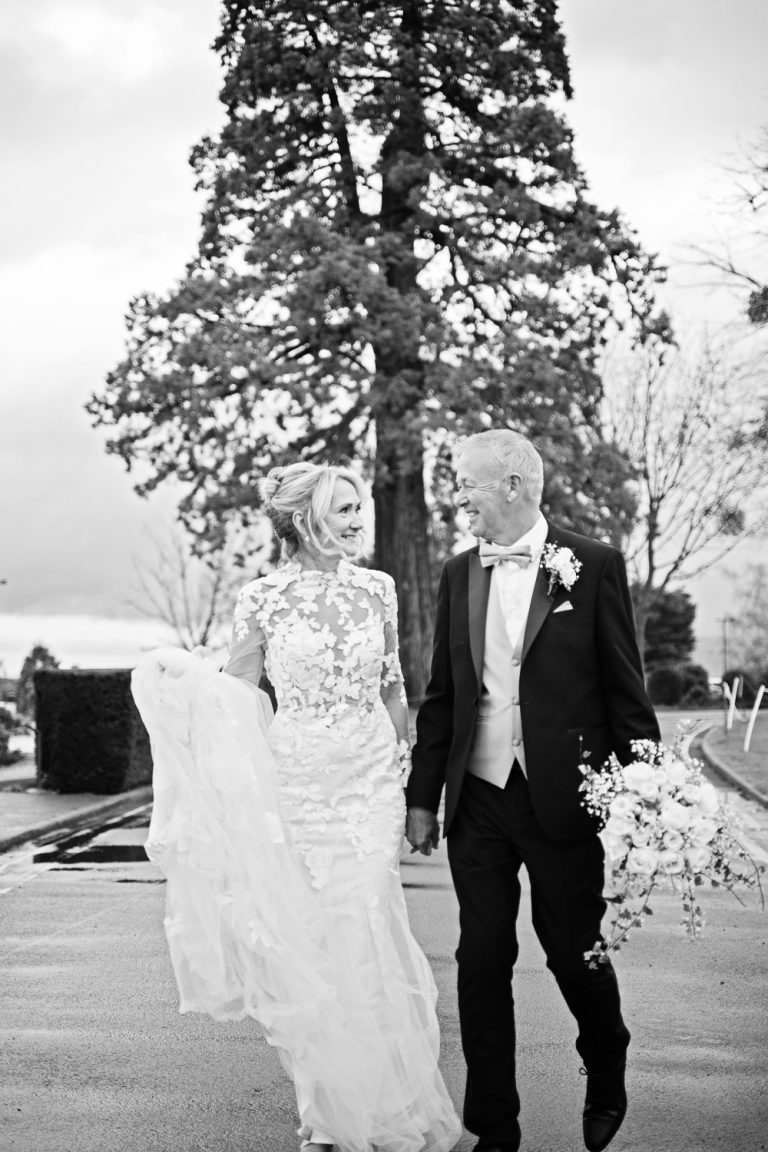 B&W candid moment of bride and groom at Tewkesbury Park wedding.