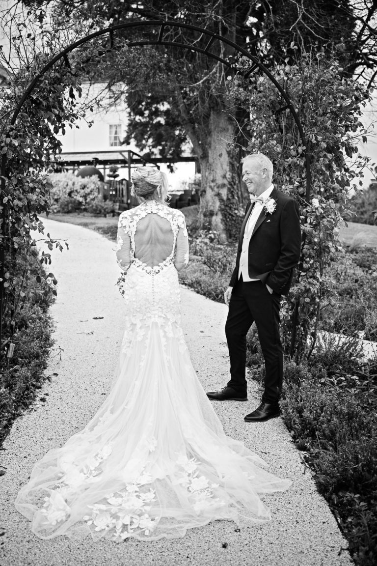 Classic b&W photo of the back of the brides wedding dress at Tewkesbury Park