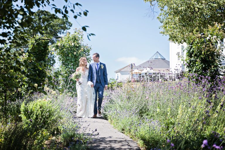 Candid moment of Bride and groom take a break in the gorgeous gardens at Tewkesbury Park.