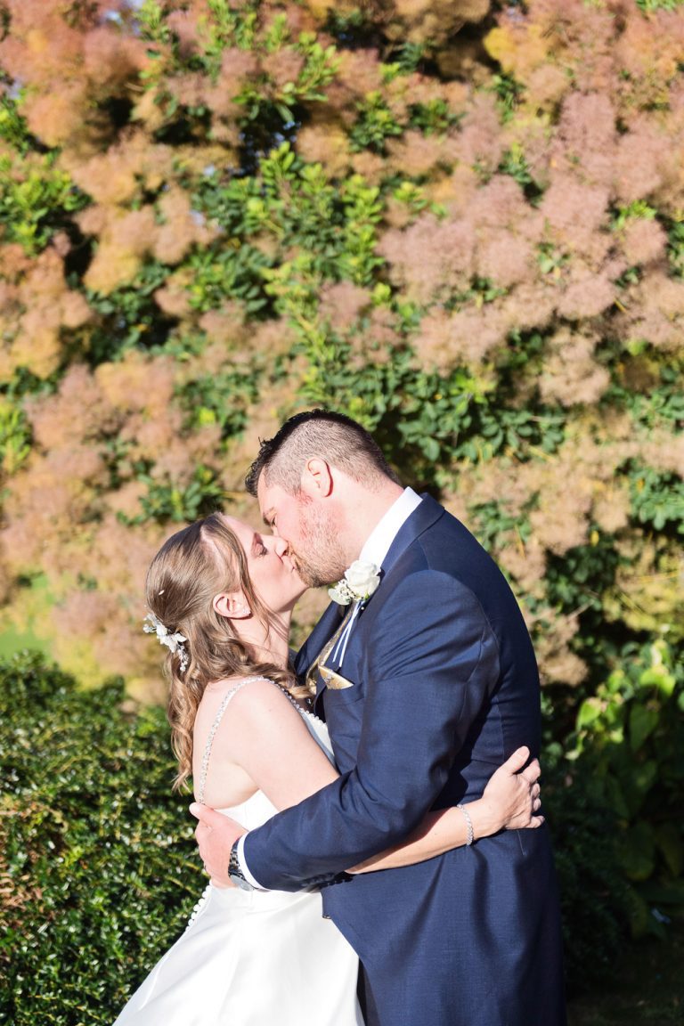 Bride and groom grab a moment in the gorgeous grounds at Tewkesbury Park.