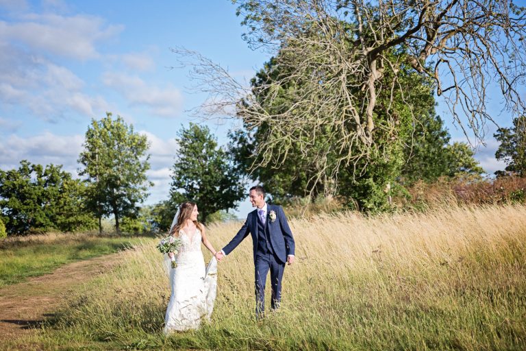 Candid moment of Bride and groom grab a moment in the gorgeous grounds at Tewkesbury Park.