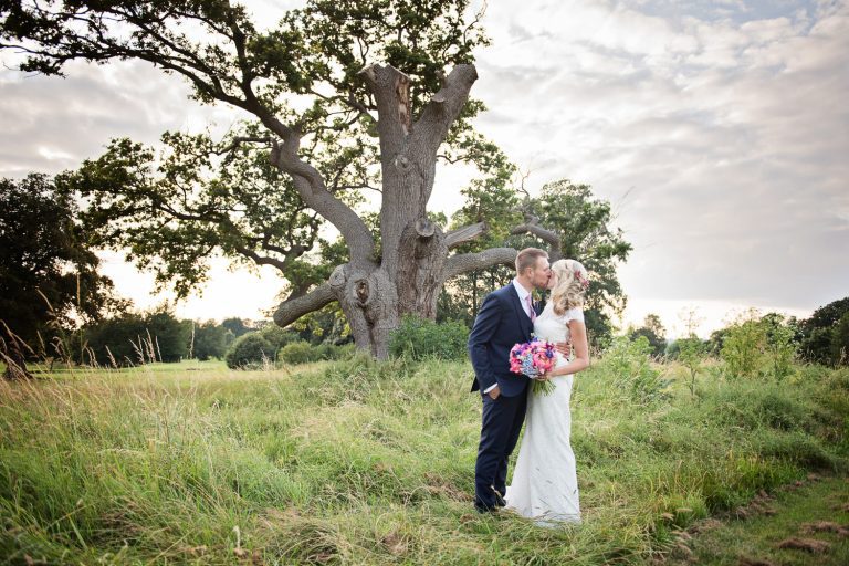 Bride and groom grab a moment in the gorgeous grounds at Tewkesbury Park.