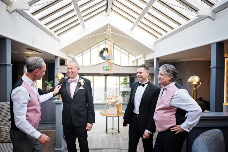 Groomsmen getting ready in the lobby of Tewkesbury Park Hotel.