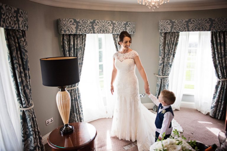 Bride holds hand with her son in the bridal suite King Richard 111 at Tewkesbury Park.