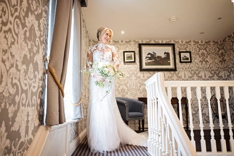 Bride, just about to walk down the stairs at Tewkesbury Park