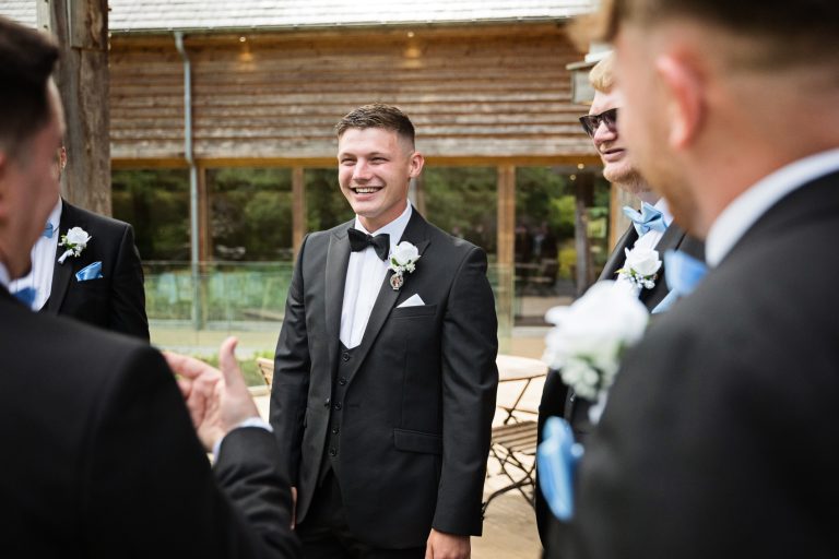 Groom chatting to his groomsmen.