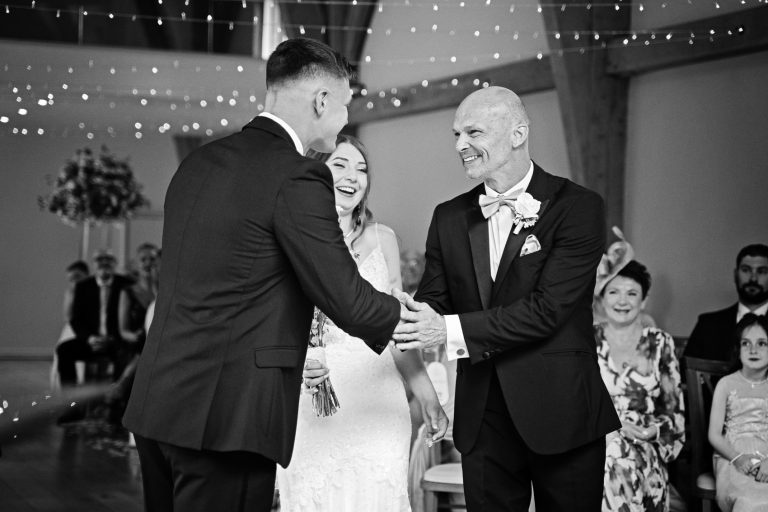 Father of the bride gives his daughter away at The Mill Barns. B&W photo.