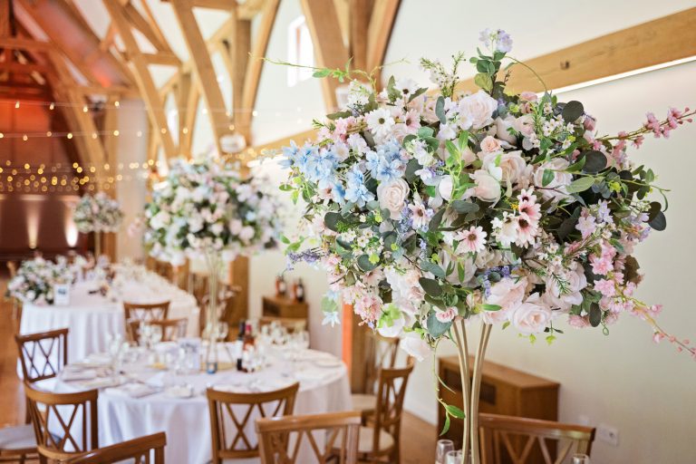 Floral bouquets set up for the wedding breakfast at The Mill Barns.