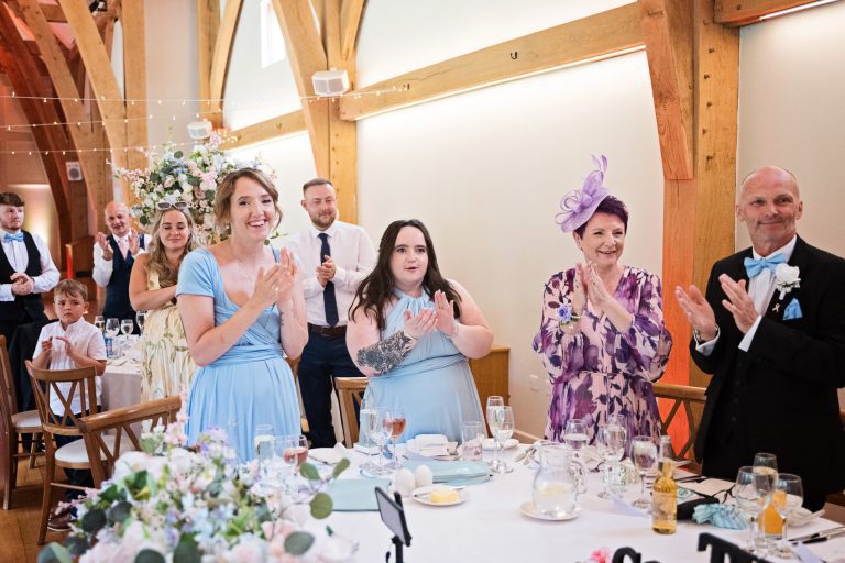 Wedding guests celebrate by clappping hands