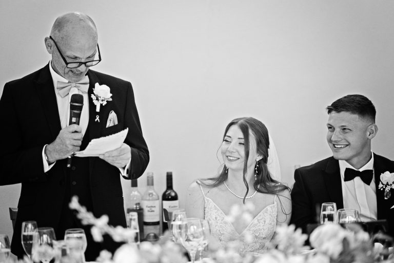 B&W image of the father of the bride delivering a speech.