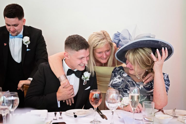 Candid, storytelling photo of wedding guests enjoying themselves naturally at The Mill Barns.